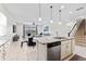 Open-concept kitchen with granite countertops, island seating, and stainless steel appliances at 12377 Streambed Dr, Riverview, FL 33579
