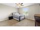 Cozy bedroom with carpet, ceiling fan, window with blinds and a metal frame bed at 12919 Whittington Ct, Largo, FL 33773
