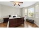 A bedroom with hardwood floors, windows that let in natural light, and a ceiling fan at 12919 Whittington Ct, Largo, FL 33773