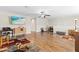 A large bonus room with lots of open space, a ceiling fan, and hardwood floors at 12919 Whittington Ct, Largo, FL 33773
