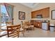 Clubhouse featuring table, chairs, cabinets, microwave and view through window at 12919 Whittington Ct, Largo, FL 33773