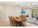 Dining area features a wooden table with four chairs, chandelier, and tile flooring at 12919 Whittington Ct, Largo, FL 33773