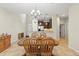 Dining area adjacent to the kitchen features a wooden table with chairs and tile flooring at 12919 Whittington Ct, Largo, FL 33773