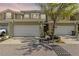 Charming townhome featuring a two-car garage, well-maintained landscaping, and appealing architectural details at 12919 Whittington Ct, Largo, FL 33773