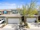 Townhouse with two-car garage, neutral stucco, well-manicured landscaping, and mature shade tree at 12919 Whittington Ct, Largo, FL 33773