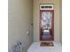 View of the front door with a decorative screen door and welcome mat at 12919 Whittington Ct, Largo, FL 33773