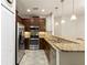 Modern kitchen with stainless steel appliances and dark wood cabinets at 12919 Whittington Ct, Largo, FL 33773