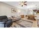 Comfortable living room featuring tile floors, a ceiling fan, and neutral-toned furnishings at 12919 Whittington Ct, Largo, FL 33773
