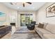 A bright and airy living room with access to the lanai, neutral paint, and comfortable seating at 12919 Whittington Ct, Largo, FL 33773