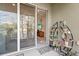 Cozy outdoor screened patio featuring a view into living room, plant stand, and pond at 12919 Whittington Ct, Largo, FL 33773
