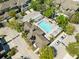 Aerial view of community pool featuring pergola, lounge seating and manicured landscaping at 12919 Whittington Ct, Largo, FL 33773
