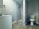 Bathroom featuring tiled shower, vanity sink, and toilet at 1409 Franklin St, Clearwater, FL 33756