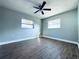 Bedroom featuring modern ceiling fan, wood floor, and two windows at 1409 Franklin St, Clearwater, FL 33756