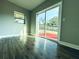 Spacious bedroom featuring sliding glass doors to a backyard deck and wood-look flooring at 1409 Franklin St, Clearwater, FL 33756