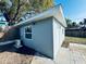 Exterior shot of the building featuring a window and white doors at 1409 Franklin St, Clearwater, FL 33756