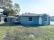 Charming single-story home with gray paint, white trim, well-maintained lawn, and detached garage at 1409 Franklin St, Clearwater, FL 33756