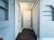 Hallway with closet doors, built-in shelving and wood-look floors at 1409 Franklin St, Clearwater, FL 33756