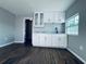 Kitchenette featuring bright cabinets, wood floor, and stainless steel sink at 1409 Franklin St, Clearwater, FL 33756