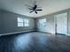 Bright living room features wood-look floors, ceiling fan, freshly painted walls and plenty of natural light at 1409 Franklin St, Clearwater, FL 33756
