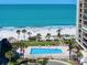 Overhead view of the pool, ocean, and beach at 1480 Gulf Blvd # 401, Clearwater Beach, FL 33767