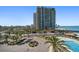 Upscale beach condos featuring a pool, tropical landscaping, and scenic ocean views at 1480 Gulf Blvd # 401, Clearwater Beach, FL 33767