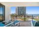 Relaxing balcony view with chairs overlooking the ocean, building and beach at 1480 Gulf Blvd # 401, Clearwater Beach, FL 33767