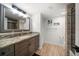 Bathroom featuring granite countertops, modern fixtures, and a shower with glass doors at 1480 Gulf Blvd # 401, Clearwater Beach, FL 33767