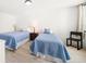 Bright bedroom with two twin beds and wood laminate flooring at 1480 Gulf Blvd # 401, Clearwater Beach, FL 33767