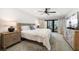 Bedroom with a ceiling fan, balcony access, and neutral decor at 1480 Gulf Blvd # 401, Clearwater Beach, FL 33767