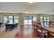 Spacious dining room area with wood floors, large windows, and a view of the balcony at 1480 Gulf Blvd # 401, Clearwater Beach, FL 33767
