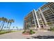 Beautiful high-rise condo building with tropical landscaping and stunning views of the ocean at 1480 Gulf Blvd # 401, Clearwater Beach, FL 33767