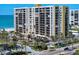 Beachfront condo building with lush landscaping, pool, and views of the water at 1480 Gulf Blvd # 401, Clearwater Beach, FL 33767