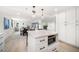 Open-concept kitchen featuring a quartz island with stainless steel appliances and eat-in dining space at 1480 Gulf Blvd # 401, Clearwater Beach, FL 33767