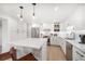 Modern kitchen with stainless steel appliances, bright white cabinets, and an island with counter seating at 1480 Gulf Blvd # 401, Clearwater Beach, FL 33767