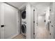 Convenient in-unit laundry with stacked washer and dryer, plus access to the ensuite bathroom at 1480 Gulf Blvd # 401, Clearwater Beach, FL 33767