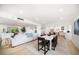 Bright open-concept living area with modern white decor flows into the dining and kitchen areas at 1480 Gulf Blvd # 401, Clearwater Beach, FL 33767