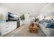 Stylish living room featuring a large TV, custom built-ins, and comfortable seating arrangement at 1480 Gulf Blvd # 401, Clearwater Beach, FL 33767