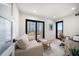 Bright home office with neutral decor, a comfortable couch, and a balcony overlooking the ocean at 1480 Gulf Blvd # 401, Clearwater Beach, FL 33767