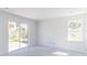 Open living room boasts natural light from sliding glass doors and a view of lush greenery at 15513 Aldama Cir, Port Charlotte, FL 33981