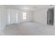 Unfinished living room with tray ceilings and a large front door with sidelights for plenty of natural light at 15513 Aldama Cir, Port Charlotte, FL 33981