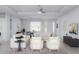 Bright living room offering comfortable seating, neutral tones, a ceiling fan, and an adjacent dining area at 15513 Aldama Cir, Port Charlotte, FL 33981