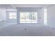 Bright living room showcasing sliding glass doors to the backyard, and large windows at 15513 Aldama Cir, Port Charlotte, FL 33981