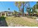 Spacious backyard featuring a deck and mature tropical landscaping, perfect for relaxation and outdoor activities at 1600 Delaware Ne Ave, St Petersburg, FL 33703