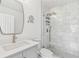 Modern bathroom with a glass shower, marble tiling, and a large vanity with a frameless mirror at 1600 Delaware Ne Ave, St Petersburg, FL 33703