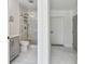 Modern bathroom featuring updated gray vanity, marble tile flooring, and glass shower at 1600 Delaware Ne Ave, St Petersburg, FL 33703