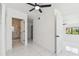 Bright bedroom featuring a ceiling fan, closet, an ensuite bathroom with tiled shower at 1600 Delaware Ne Ave, St Petersburg, FL 33703