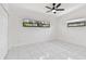 Bright bedroom with marble floors, a ceiling fan, two windows, and a double-door closet at 1600 Delaware Ne Ave, St Petersburg, FL 33703