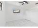 Bright bedroom with marble floors, a ceiling fan, a window and a double-door closet at 1600 Delaware Ne Ave, St Petersburg, FL 33703