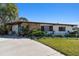 Charming single story home with stone accent, blue door and well maintained front yard at 1600 Delaware Ne Ave, St Petersburg, FL 33703