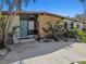 Charming home featuring a stone accent wall, blue door and lush landscaping creating inviting curb appeal at 1600 Delaware Ne Ave, St Petersburg, FL 33703
